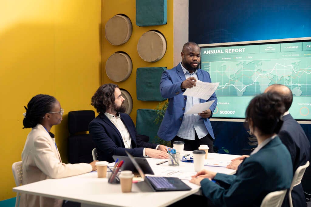 Corporate employees reviewing transactional info to improve customer satisfaction, expanding on the market. General director and his team making critical decisions regarding activity development.