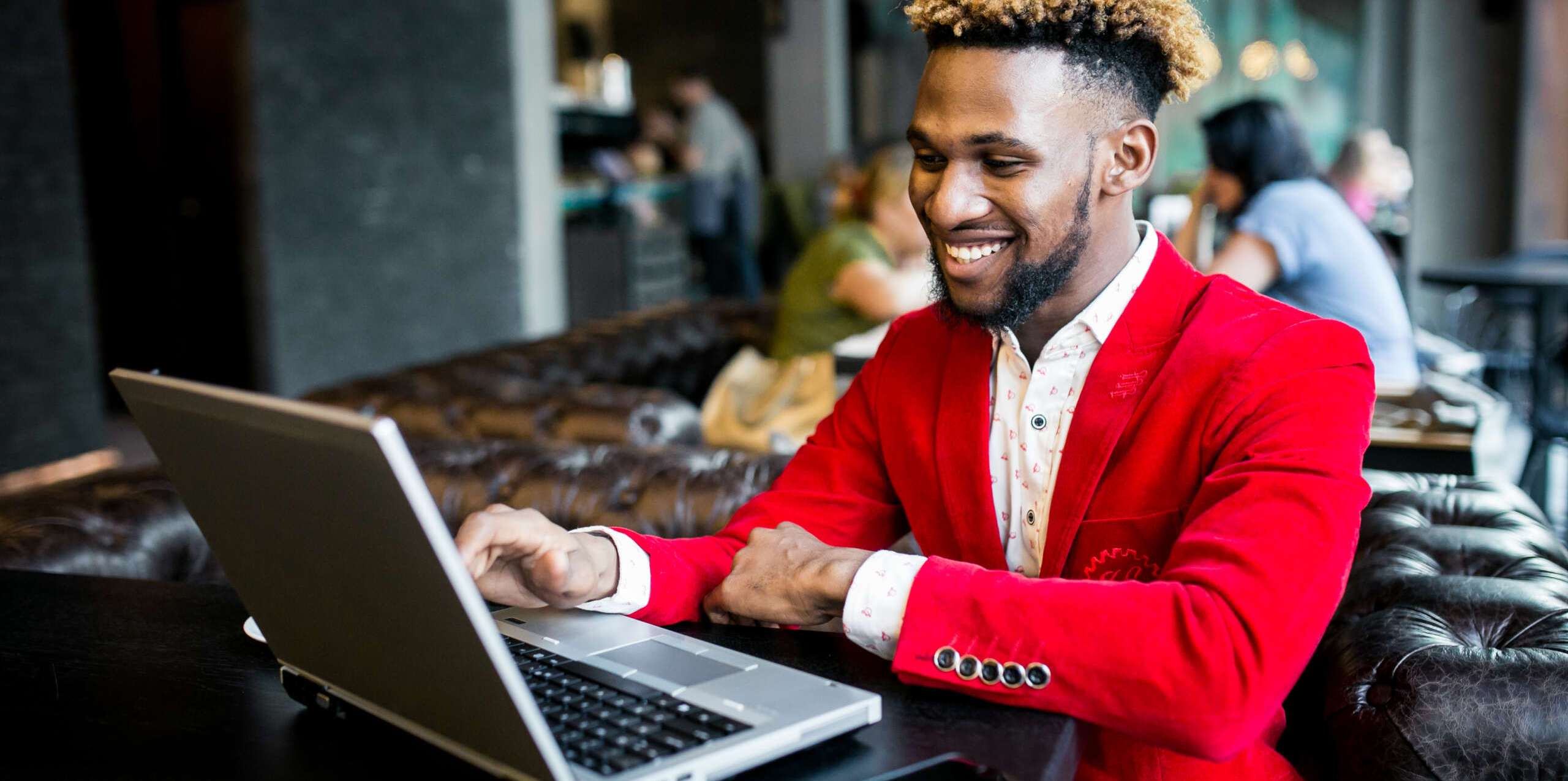 African american man in a cafe with laptop