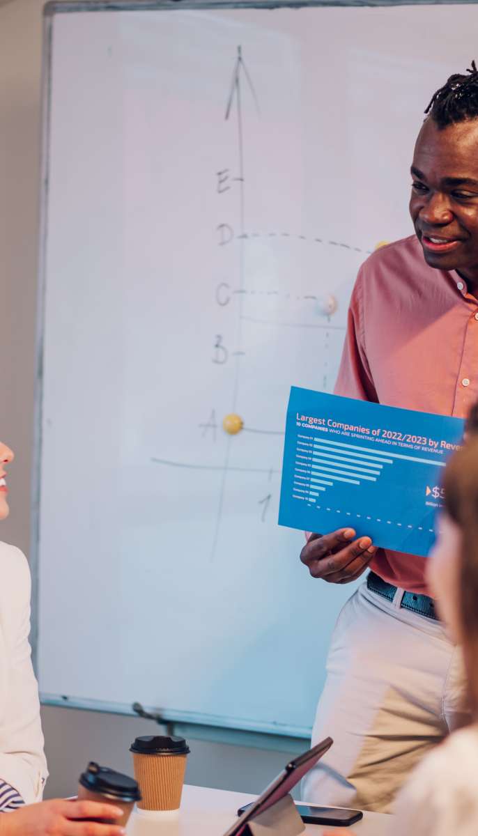 Diverse creative business team working together in the meeting room of a modern company. Brainstorming concept. Office life. Multiracial colleagues. African american male boss holding a meeting.